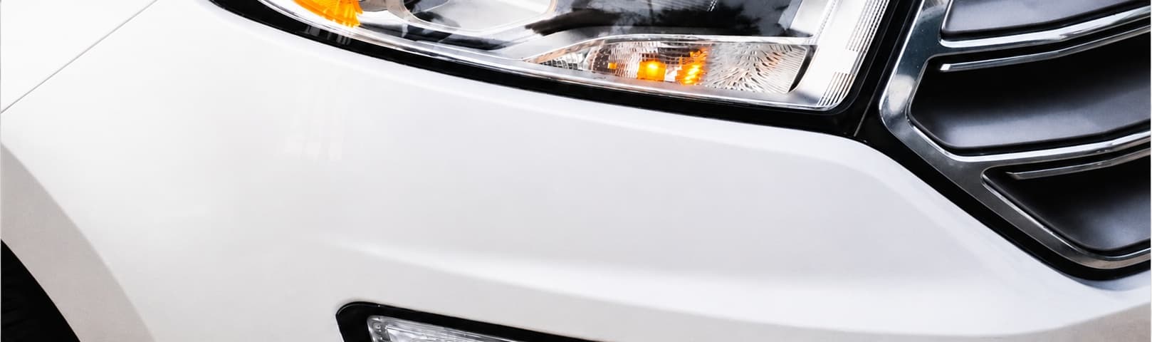 Close-up of the same white SUV's front fender, clean and undamaged
